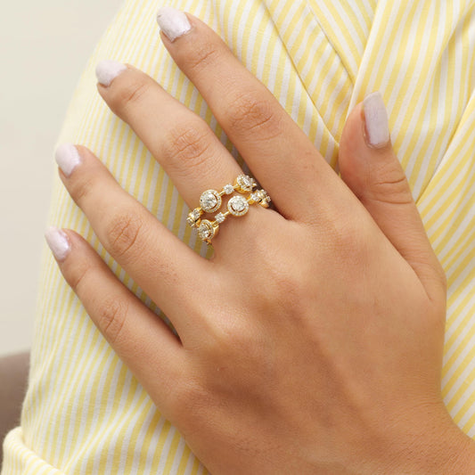 Worn on the hand — 14K yellow gold wide diamond band ring sitting across the finger