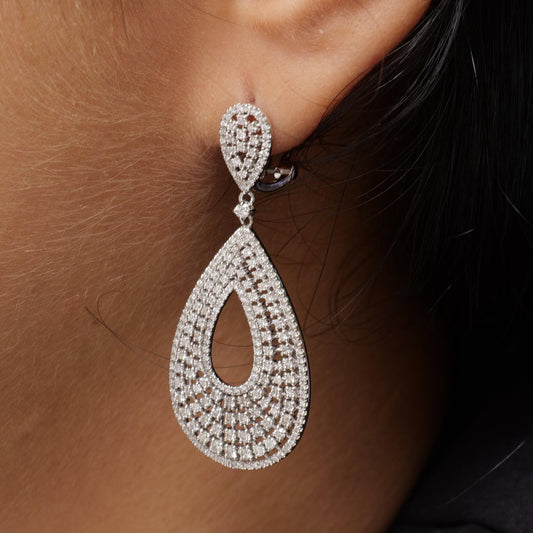 Teardrop diamond drop earrings in 14K white gold, seen from the side.