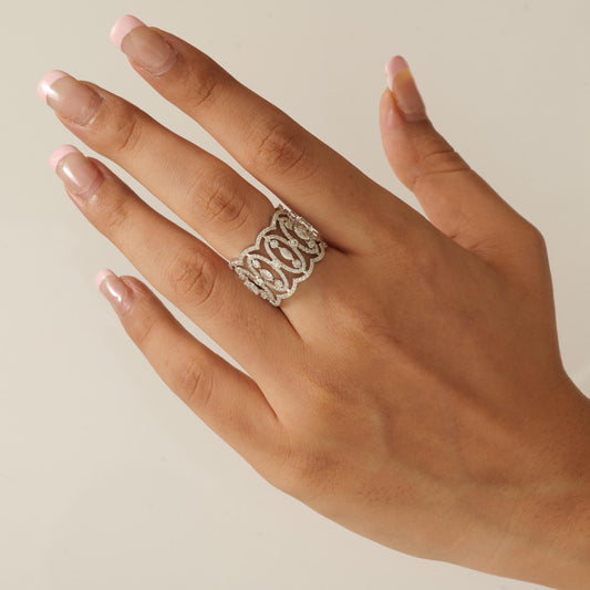 Overhead view of the filigree lattice — bezel-set natural diamonds across the wide gold band