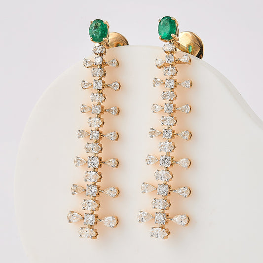 Oval emerald and fancy cut diamond drop earrings in 14K yellow gold.