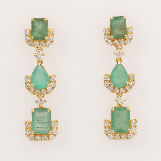 Graduated natural emerald and diamond drop earrings in 14K yellow gold.