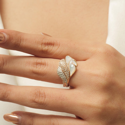 Worn on the hand — carved mother of pearl leaves framed in 14K yellow gold and diamonds