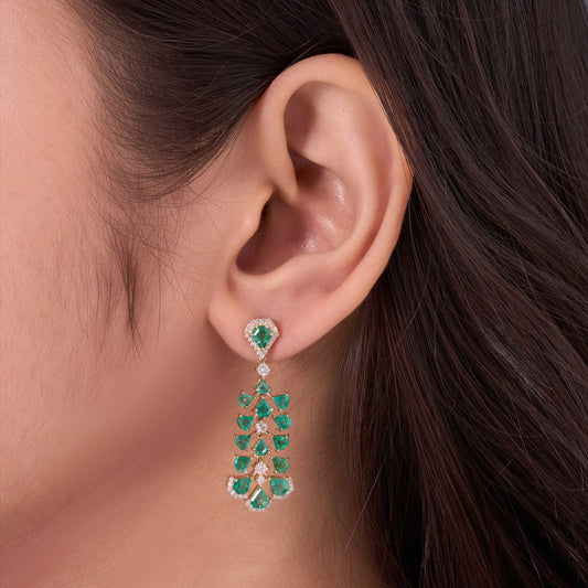 Trilliant emerald and diamond tiered chandelier earrings in 14K yellow gold, shown as a pair