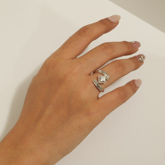 The princess halo bypass ring showing the channel-set baguettes along the crossover arms