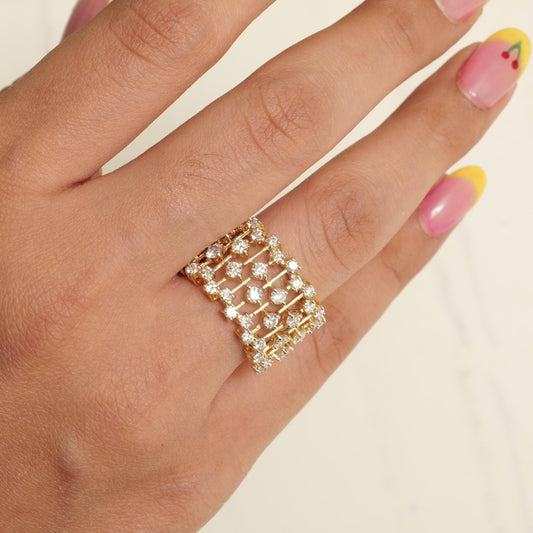 Worn on the hand — 14K yellow gold openwork cage ring covering the finger