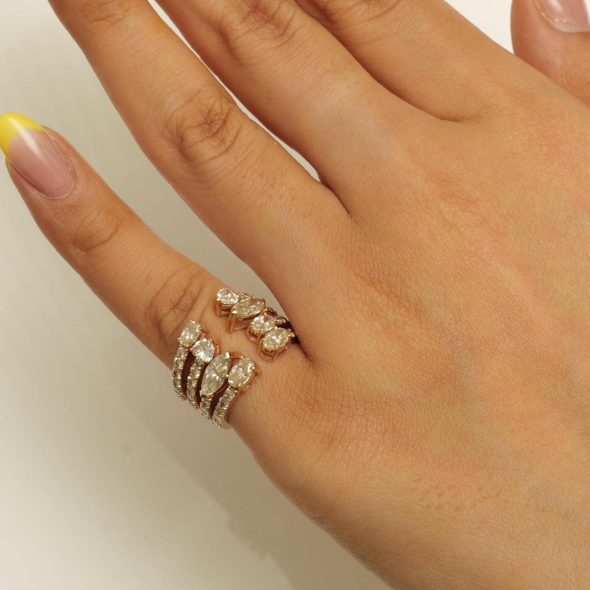 Worn on the hand — 14K yellow gold multi-row diamond band with a scattered fancy-shape cluster