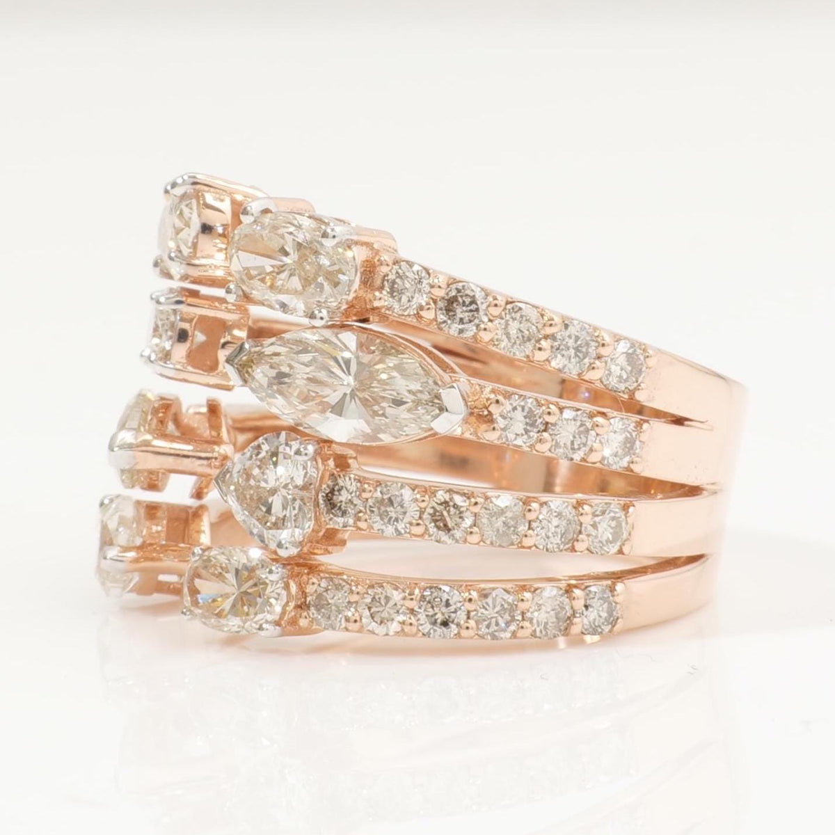 Top-down view of the fancy-shape cluster — oval, marquise and heart diamonds in 14K yellow gold