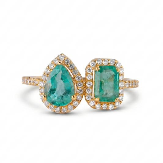 Front view of the Toi et Moi emerald ring — 14K yellow gold with two natural emeralds and diamond halos