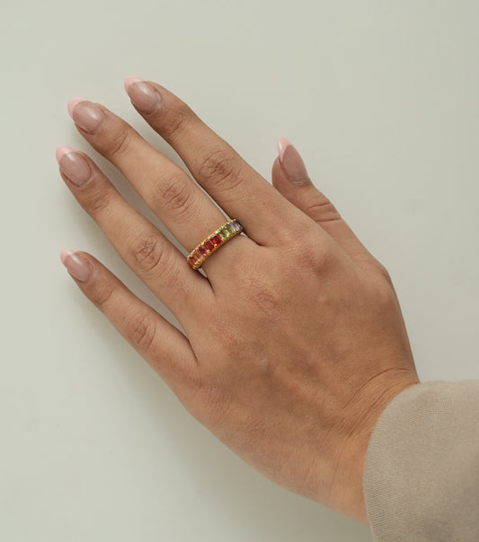 Worn on the hand — 14K yellow gold band ring with a graded row of natural sapphires