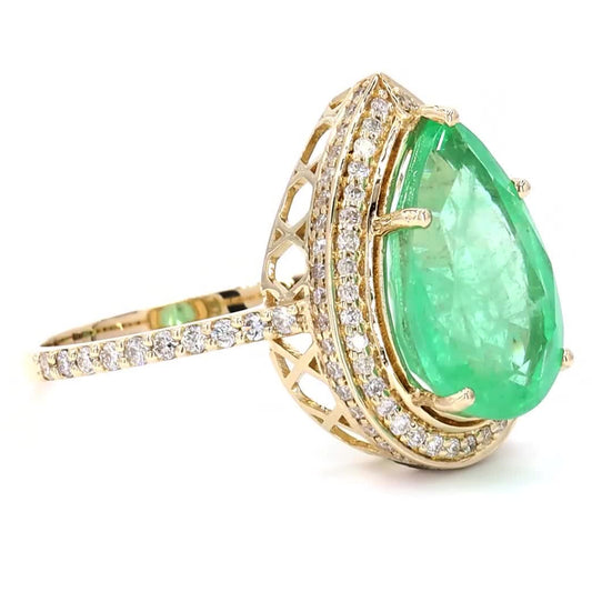 Worn on the hand — 14K yellow gold ring with a pear-shaped natural emerald in a diamond halo